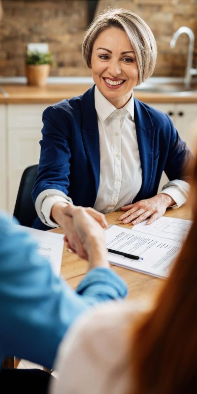 happy-real-estate-agent-shaking-hands-with-her-cli-E99ZCNQ.jpg